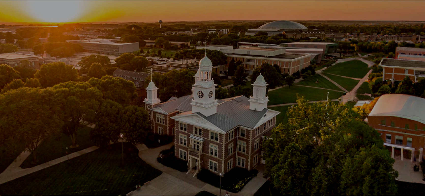 View of a university with a sunset